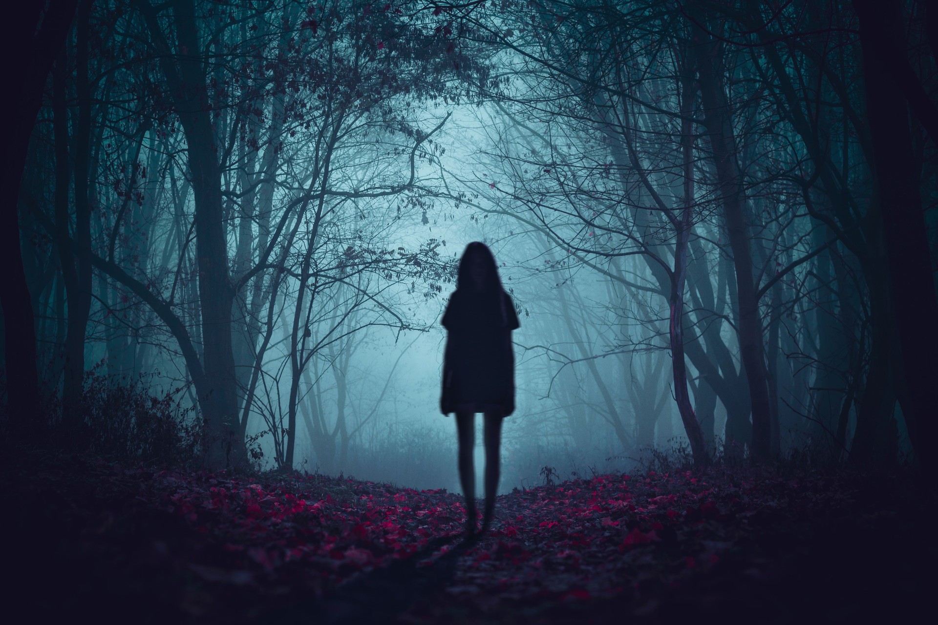 Girl on the road in a mysterious forest. Background wallpaper. Strange forest. Mystic atmosphere. Dark scary road. Paranormal another world. Ghost in the fog. The pursuit. Horrible dream.